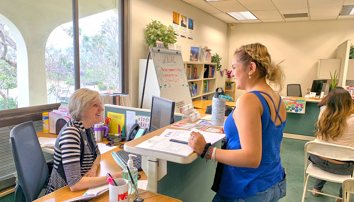 Career center representative helping a student find a job.